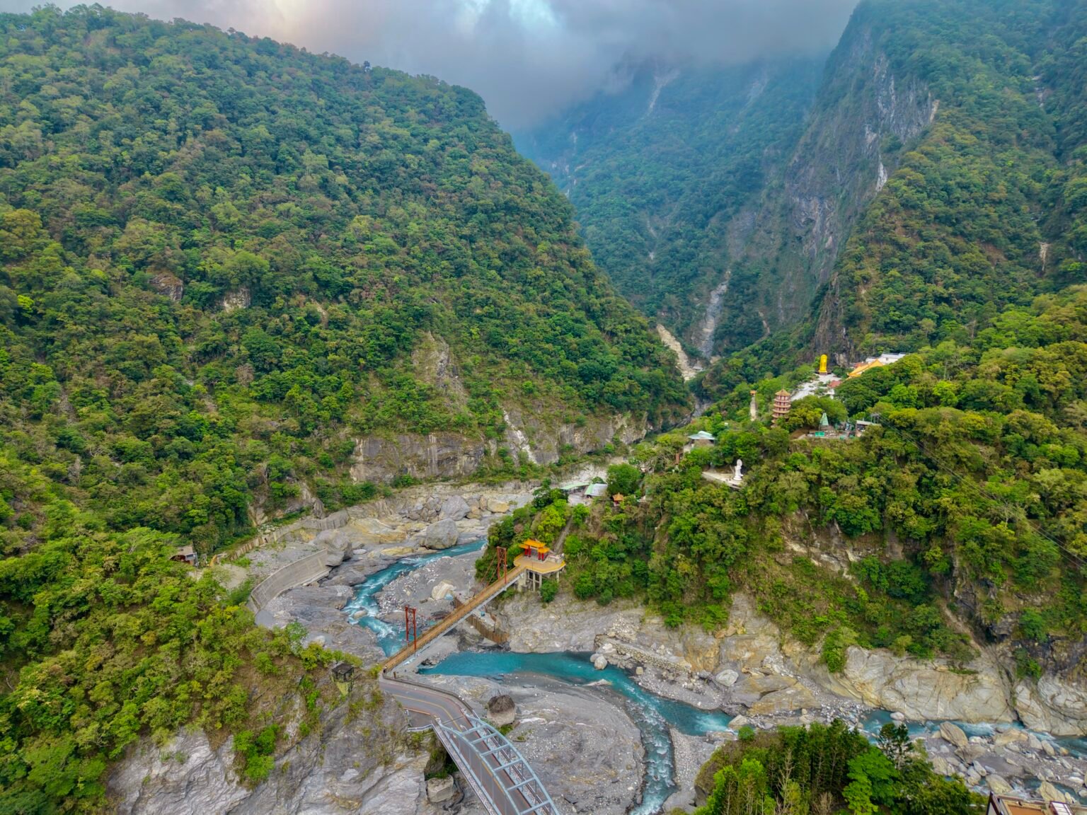 Drone view of a forested mountain gorge and river