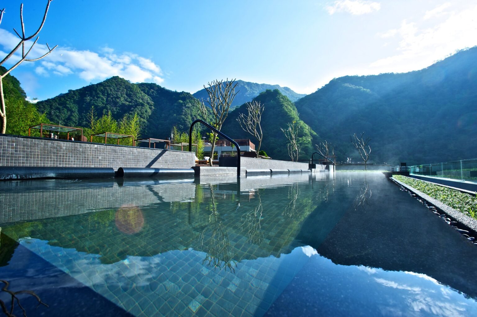 Outdoor infinity pool overlooking forested mountains